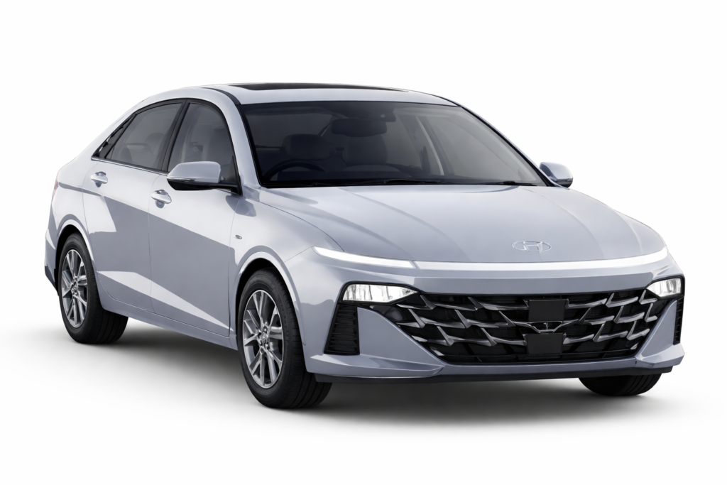 Silver Hyundai Verna sedan parked on a white background, front three-quarter view with sharp LED headlights and bold black grille design.