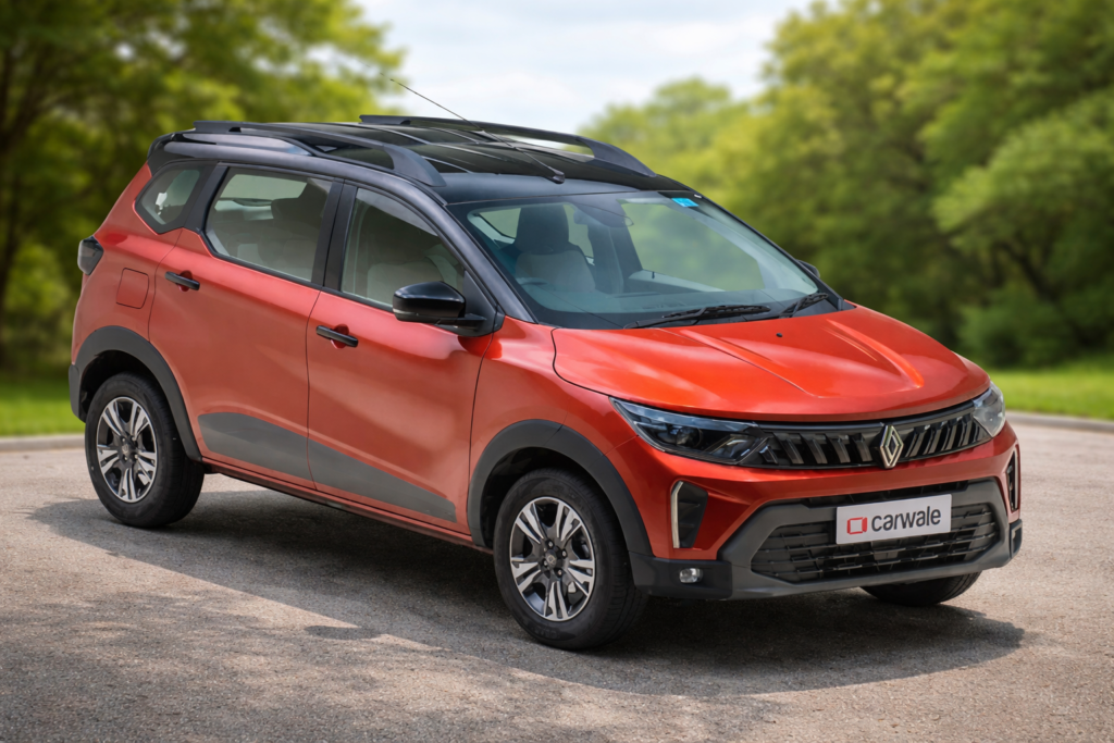 “Orange color Renault Triber compact MPV parked outdoors with modern design, roof rails, alloy wheels, and sleek front grille.”