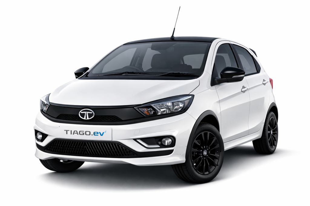 White Tata Tiago hatchback car front side view with modern design and black alloy wheels