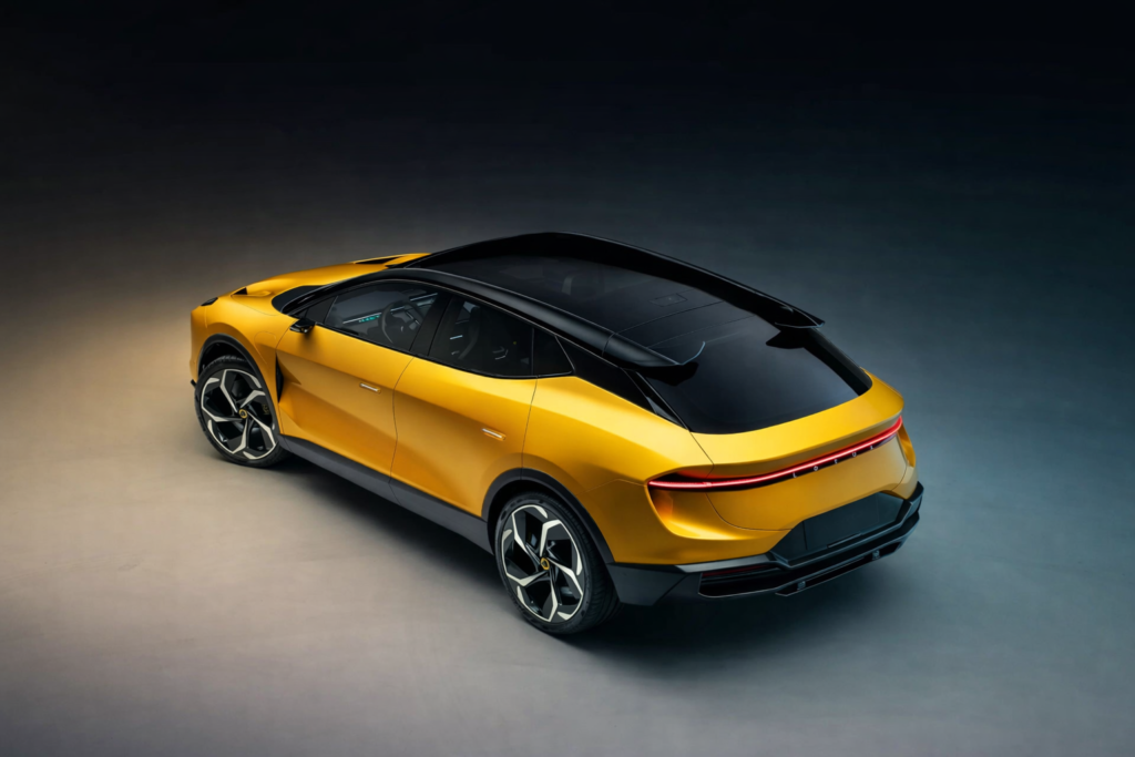 Yellow Lotus Eletre electric SUV with black panoramic roof and full-width LED tail lights in a studio setting.